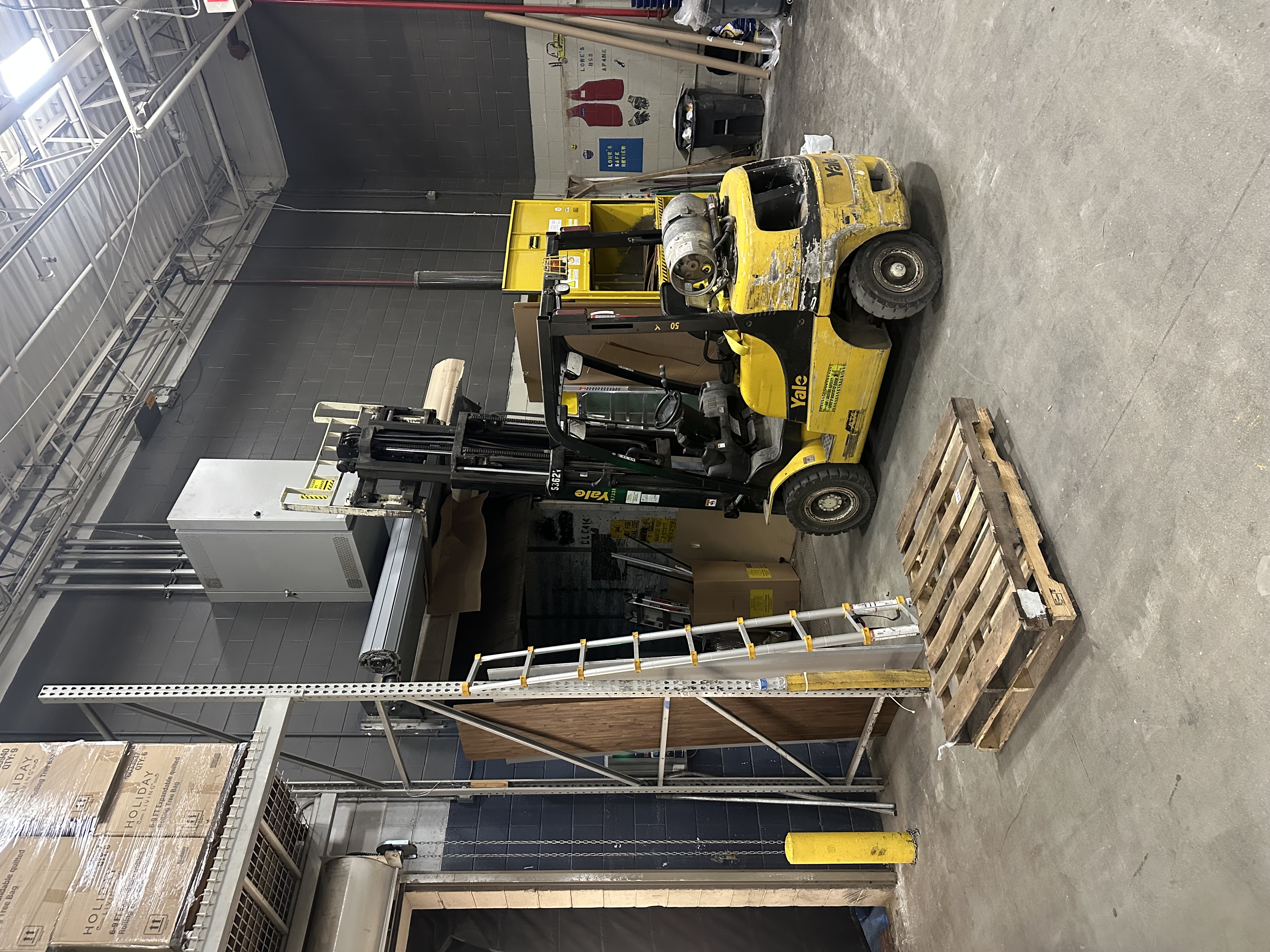 Commercial garage door job site with forklift and professional equipment at a Massachusetts business