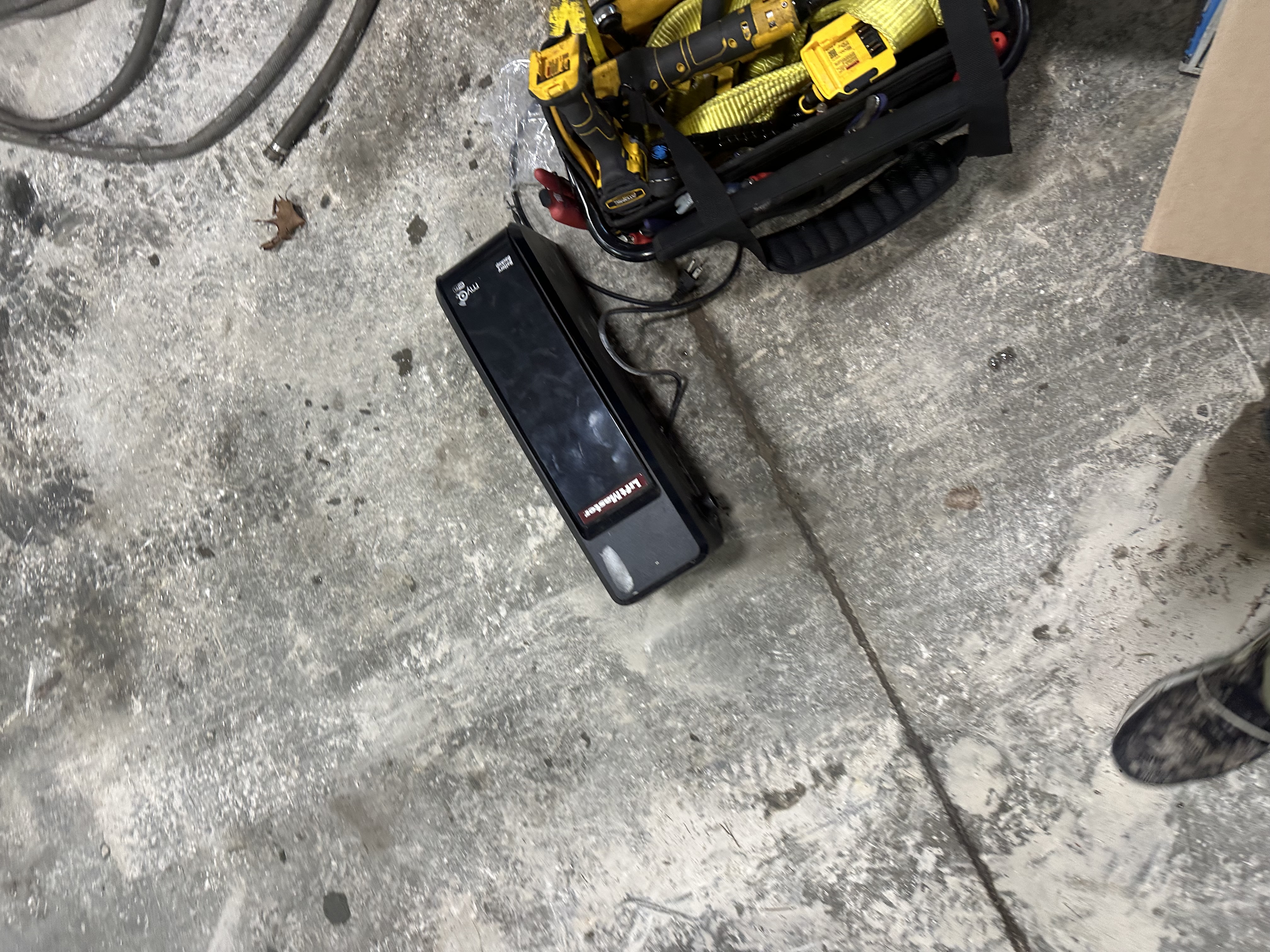 LiftMaster garage door opener unit ready for installation with professional DeWalt tool kit